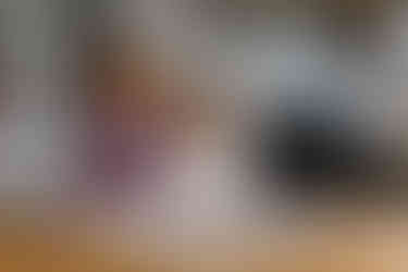 Family baking gingerbread together in their kitchen during a Christmas photoshoot.