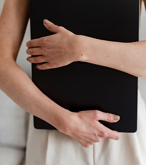 Brading Photo of a women hold a laptop in front of her torso during a brandng session