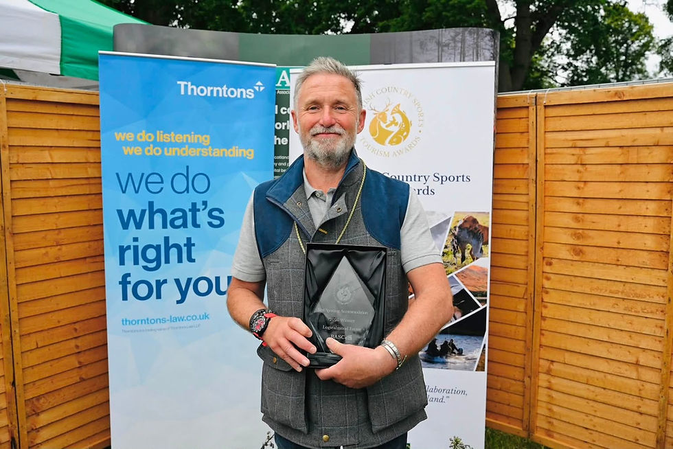 Estate manager holding award