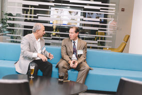 Corporate office photography two men with name tags talking