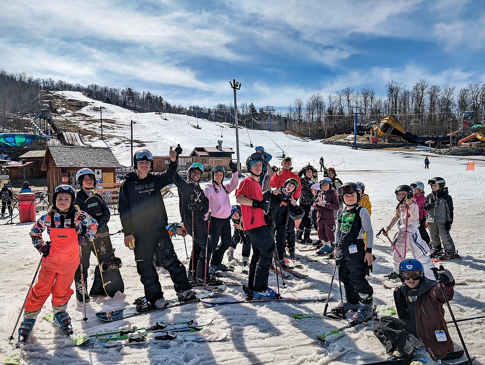 Kids at a March Break Ski & Snowboard Camp on a sunny hill