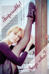 A young, graceful ballerina in a challenging pose, wearing glasses - Impossible! Says who?