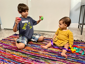An inclusive Music Together classroom filled with joy as babies, toddlers, and children aged 0-5 engage in playful musical activities. Moms and little ones bond in mommy-and-me sessions, surrounded by colorful instruments, smiling faces, and rhythmic movements.