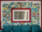 Colorful tiles with artwork border a sign reading "Welcome to Lyons Community Centre." Four teal chairs are in the foreground.