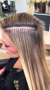 Eye-level view of a stylist applying KTIP extensions in a Miami salon
