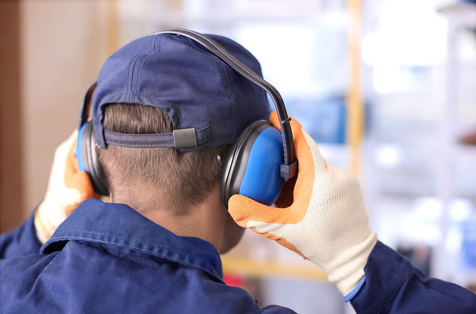 Worker wearing earmuffs for hearing protection