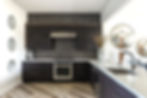 Modern kitchen with dark cabinets, white counters, wood floor