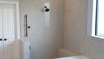 Q quartz from MSi shower walls, tub deck with mitered edges and tub surround made by JG Natural Stone LLC.