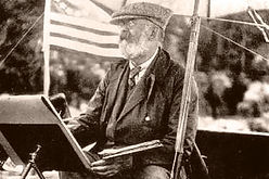 A man painting outside