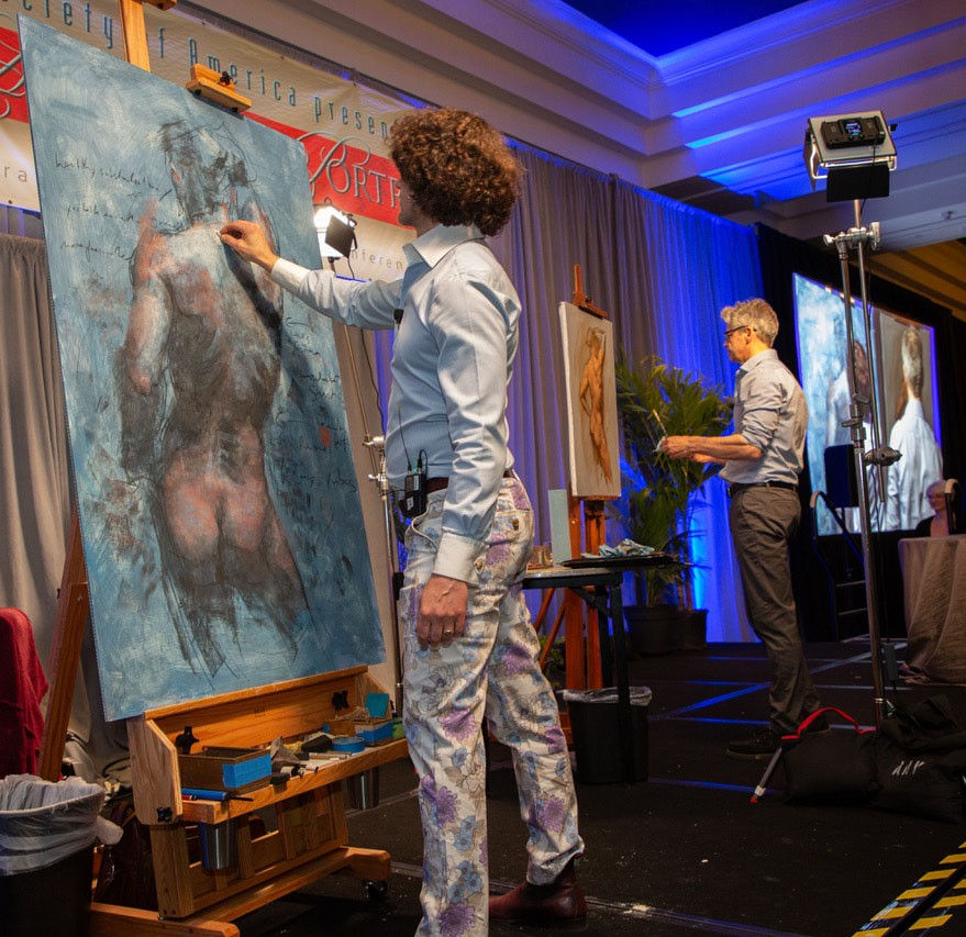 Shane Wolf and Robert Liberace offered a unique artistic experience as they simultaneously portrayed the same nude figure. Each artist captured the form, light, and emotion of the subject through their own distinctive style and interpretation.