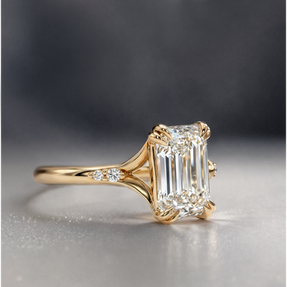Emerald cut engagement ring with diamond accented split shank. Designed to stack flush with wedding bands.