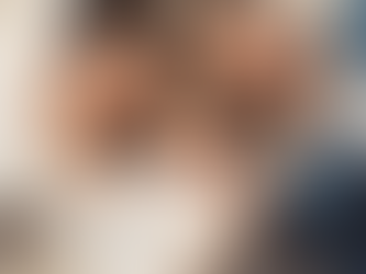 Parents and young daughter relaxing and playing on the floor, symbolizing a safe and nurturing home environment for hiring a nanny.