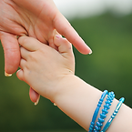 woman holding toddler's hand