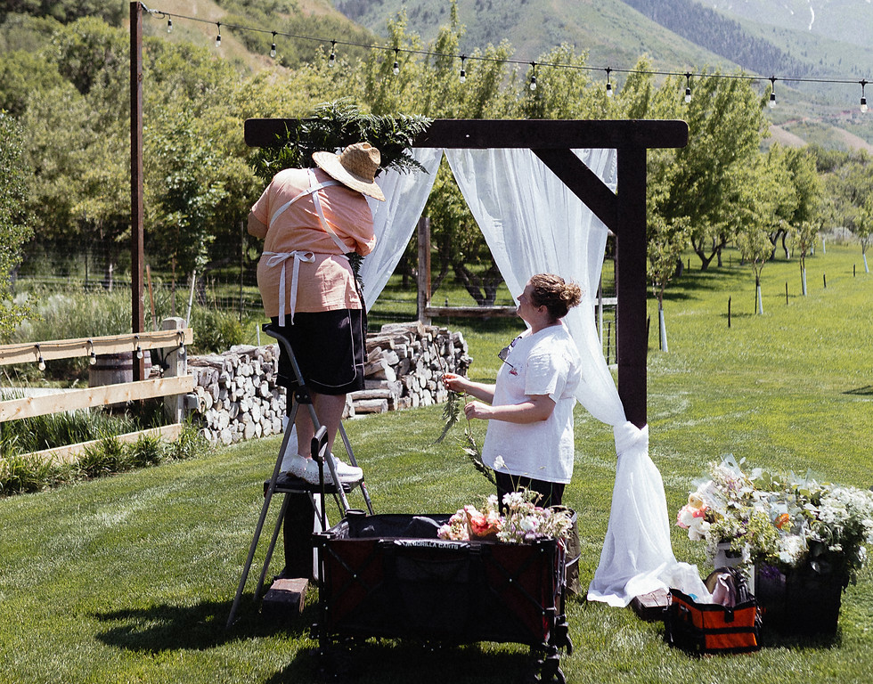 florists working on a wedding arch at quiet meadow farm