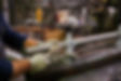 Metal pipe in the hands of a worker in the workshop for the manufacture of lamp posts. Pro