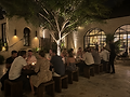 Picture of Casa Palma Courtyard dinner event at night using the custom courtyard table by Mesa and Maple Custom Furniture Studio