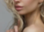 Woman's face and neck, blonde wavy hair