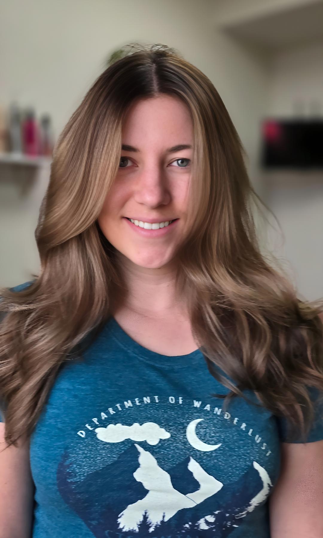 Client at Flaired Beauty in El Paso showing off fresh gray blending and low-maintenance highlights with soft, natural waves.