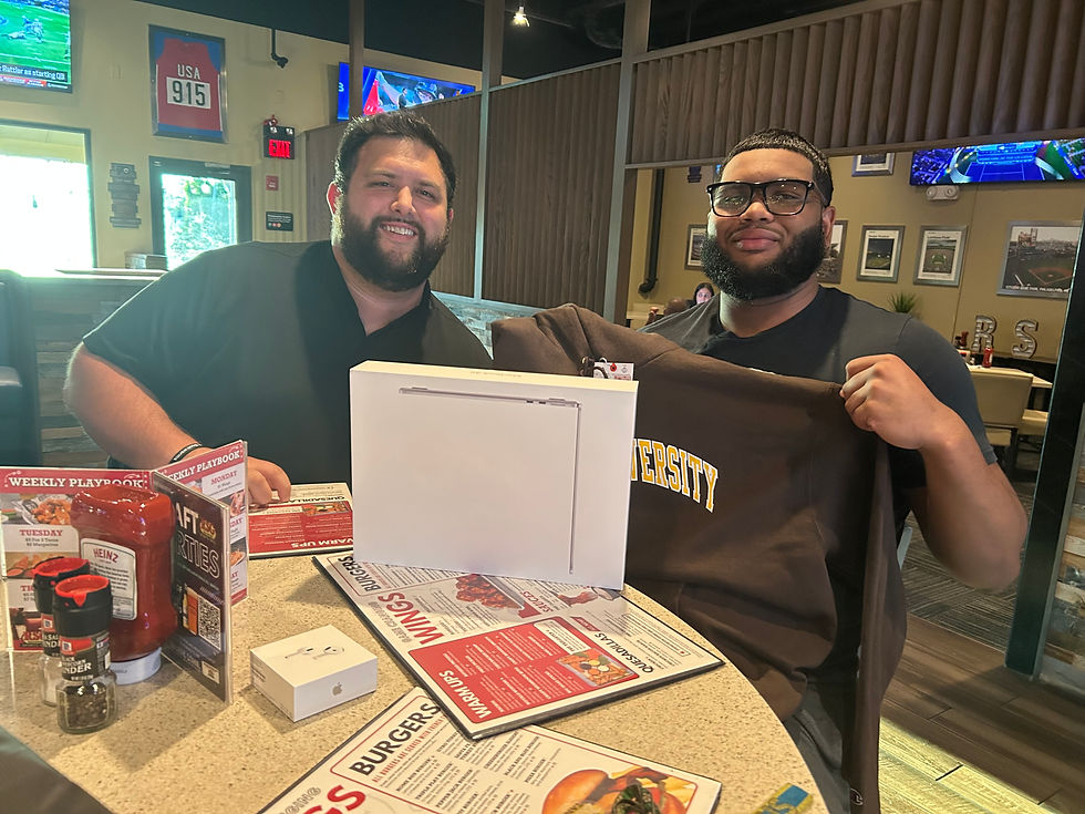 Eye-level view of a sleek Apple MacBook Air on a wooden desk, ready for a student’s use