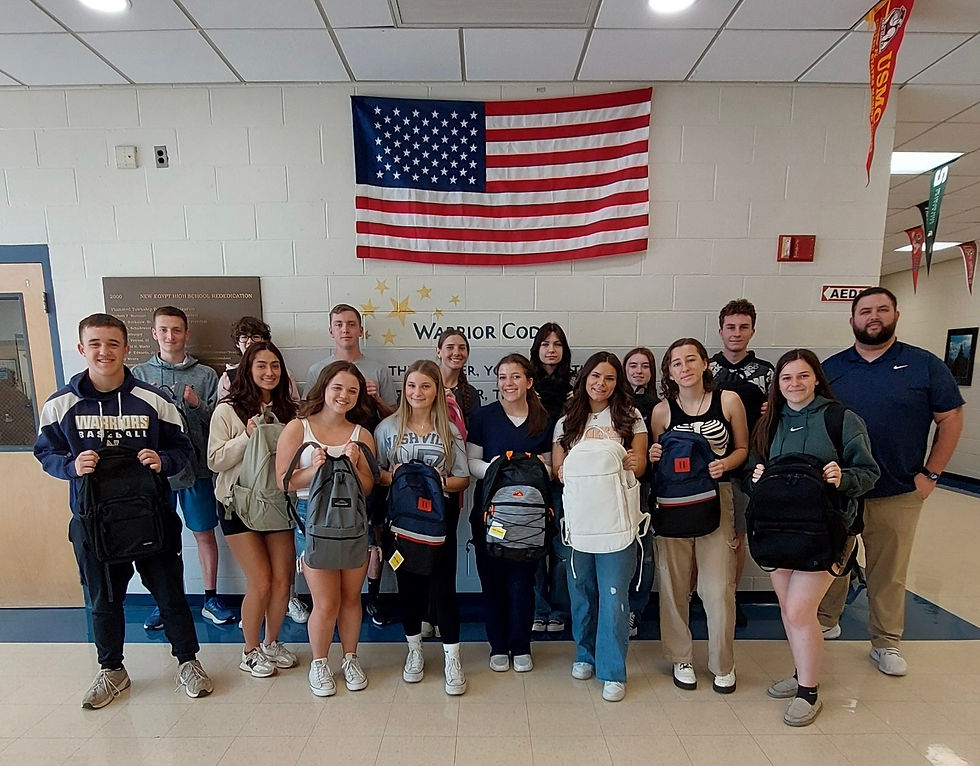 Students in the New Egypt High School National Honor Society and Executive Director of Ballers & Bookworms, Tyler Kazio with the backpacks they put together to donate