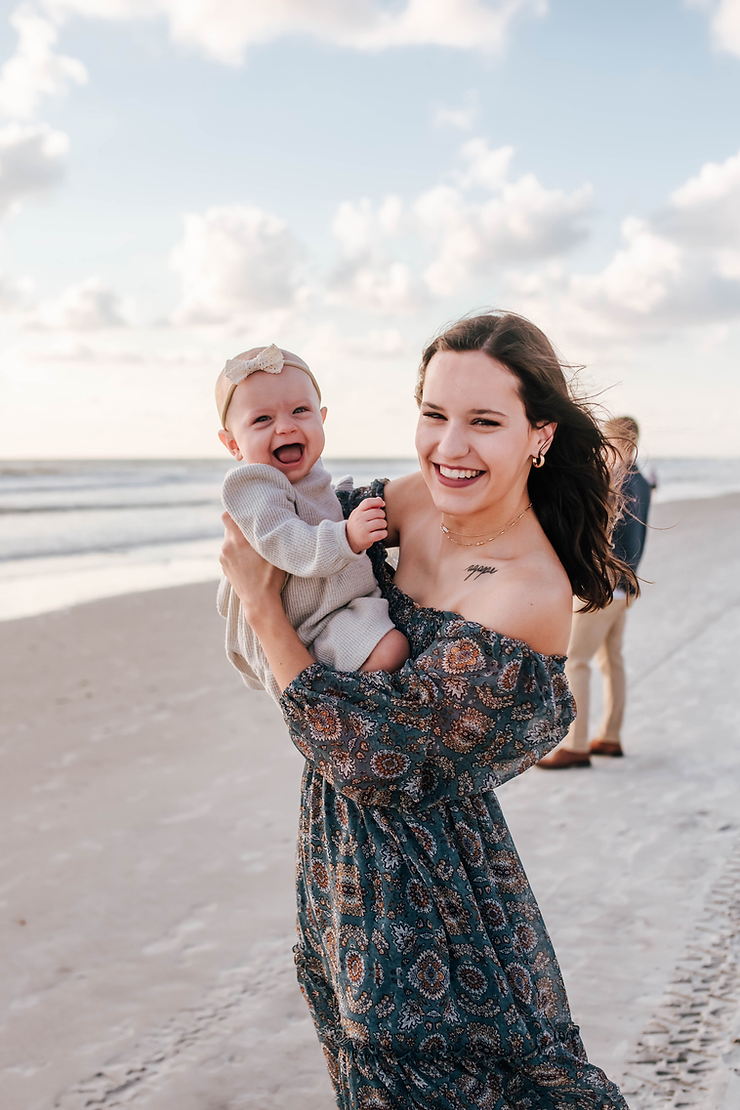 smiling baby girl and mom on beach family photoshoot