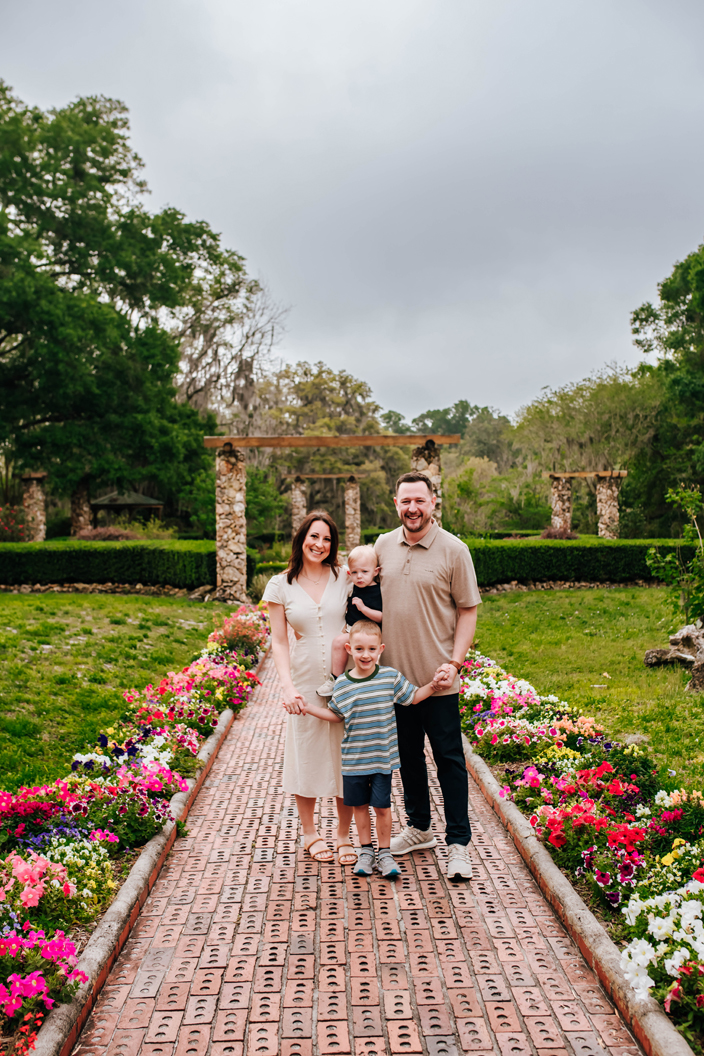 family happy together on brick walkway lined with flowers during state park family portrait session