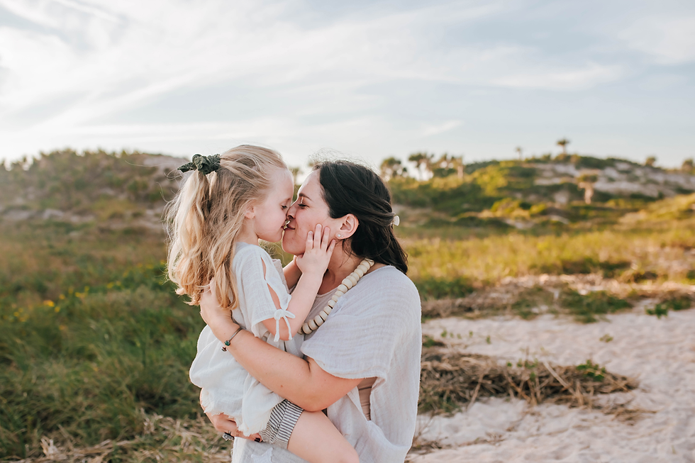 daughter giving mom a kiss