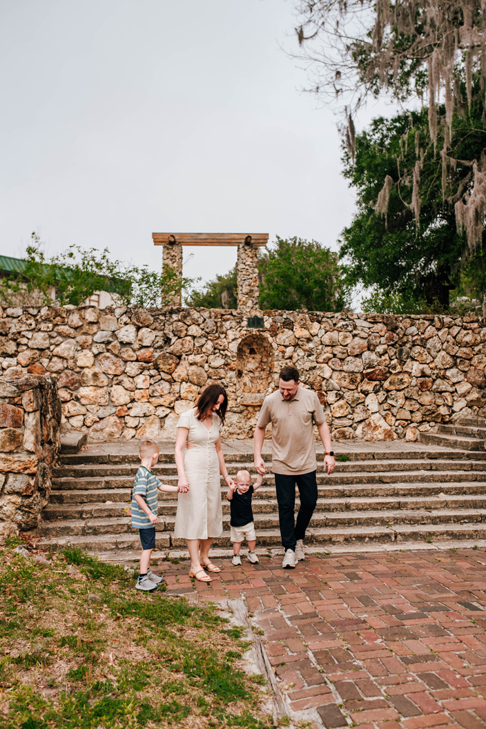family walking down historic rock steps during family photography session