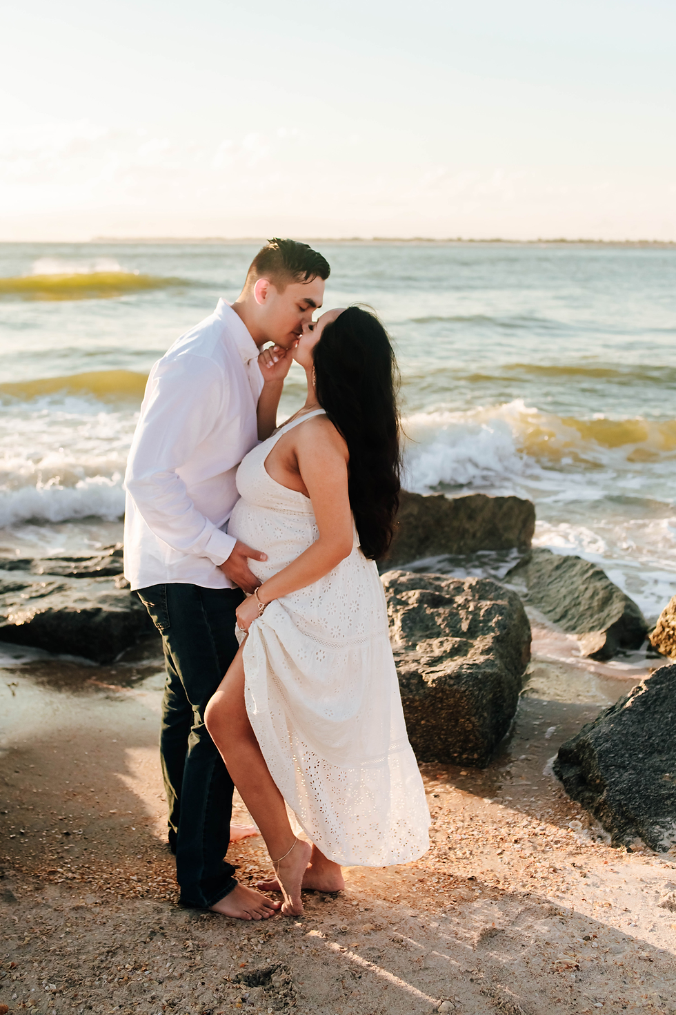 couple close together during sunrise maternity pictures