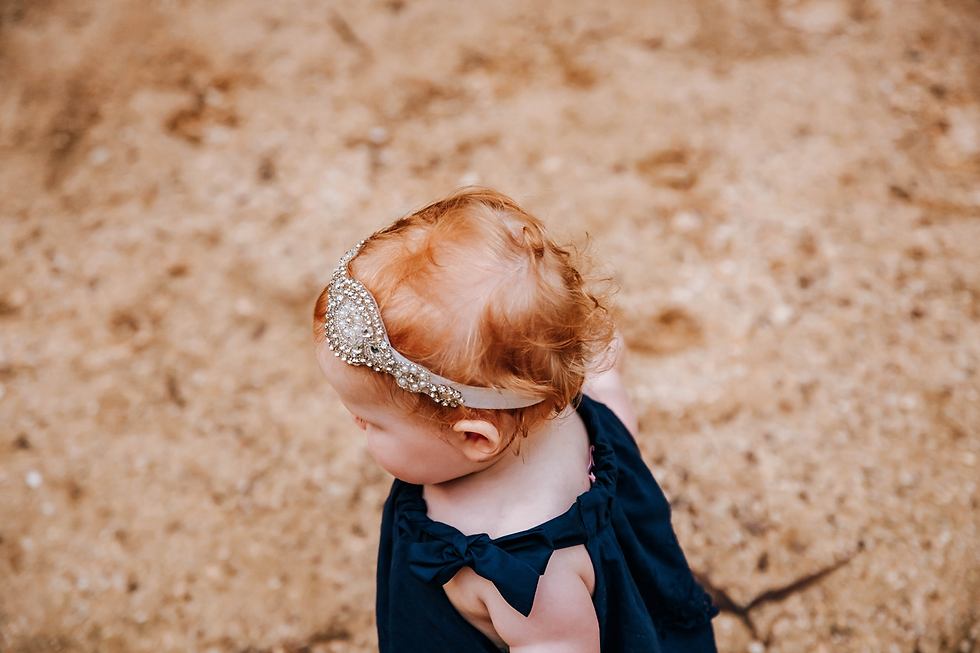 portrait of tiny red curls in toddler's hair