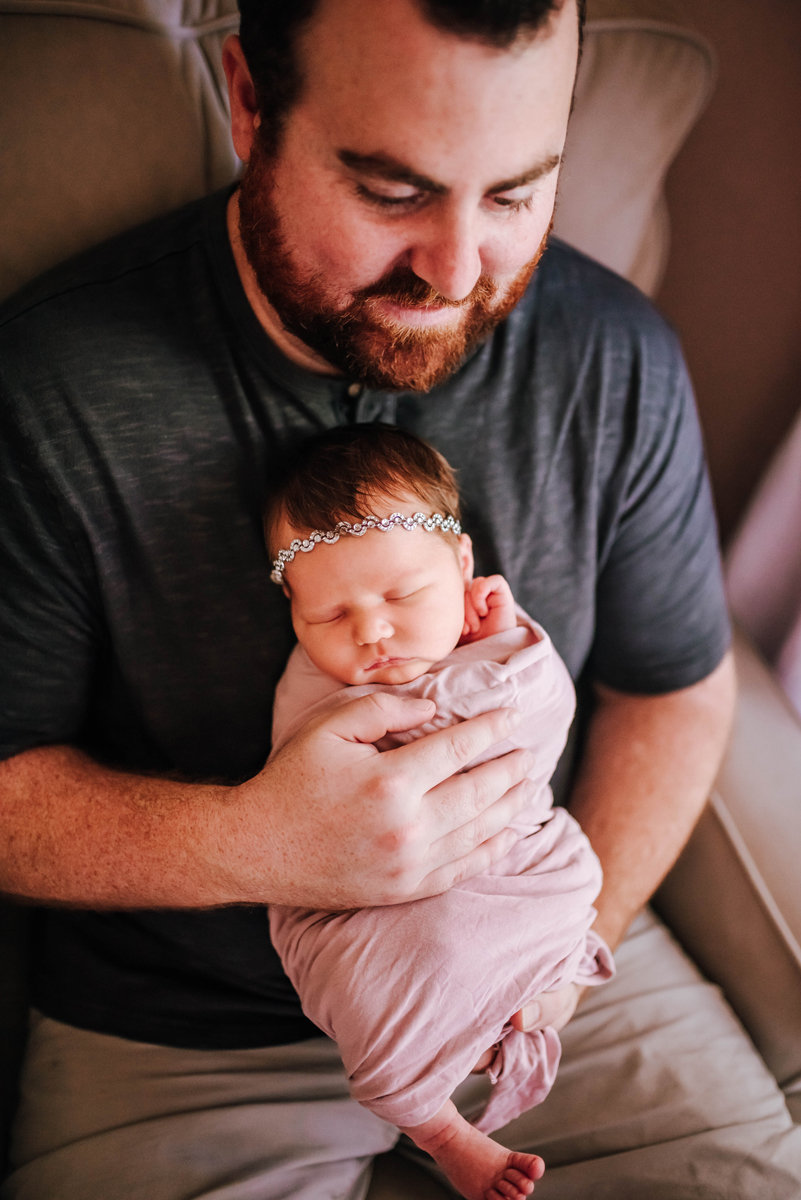 newborn photography of baby girl held by dad