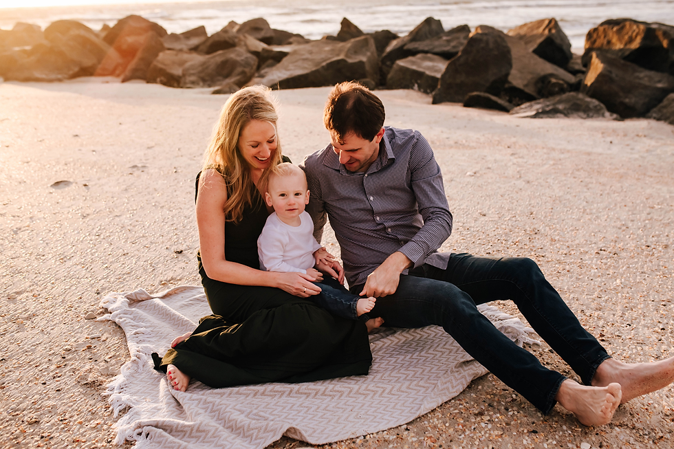 family together on blanket on beach during sunrise family photos