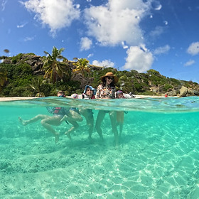 Family with children swimming in warm, crystal-clear Caribbean waters: A perfect moment of relaxation and fun during a sailing holiday around Saint Lucia and Martinique