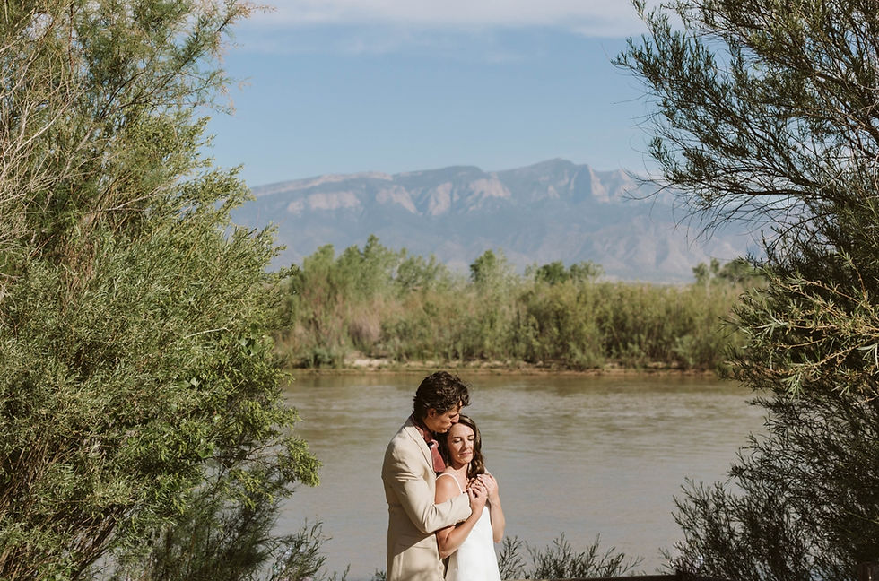 Married couple embracing next to the Rio Grande River at Tamaya Resort in Albuquerque New Mexico, Best wedding photographer in Albuquerque, Hyatt Regency Tamaya wedding