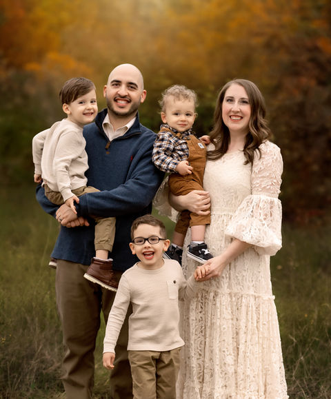 McKinney family photographer captures a joyful family of five laughing together during golden hour