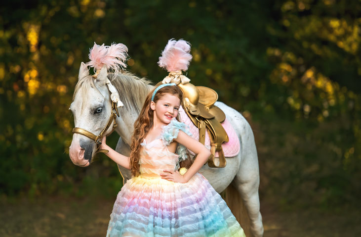 girl posing in Bentley & Lace dress with circus horse for a styled shoot with jc photography and design a mckinney family photographer