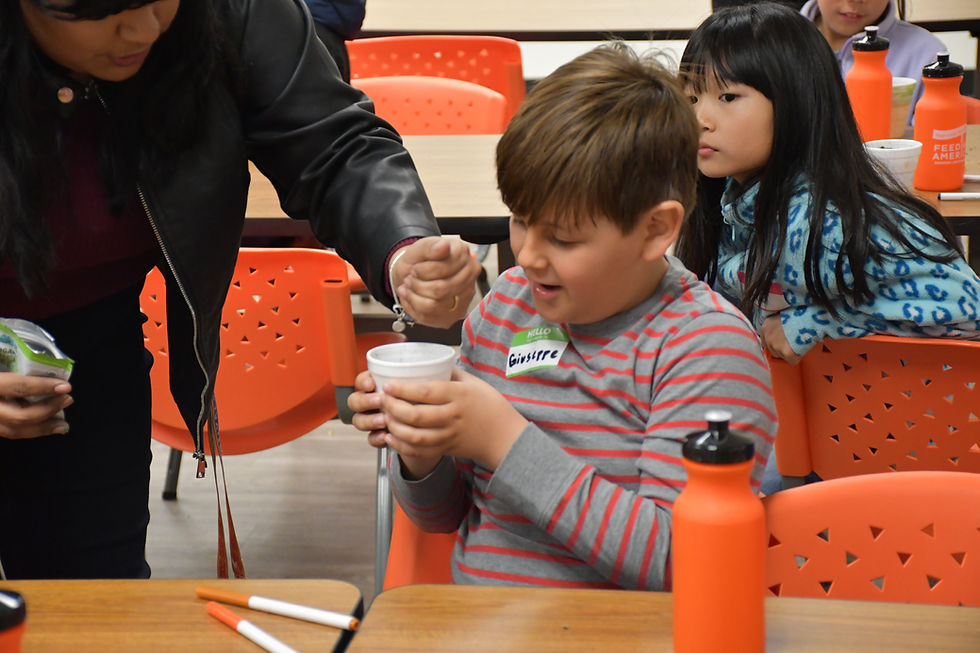 FARSB program attendee having seeds put into a Styrofoam cup.
