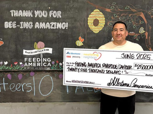 FARSB staff holding a donation check for the food bank.