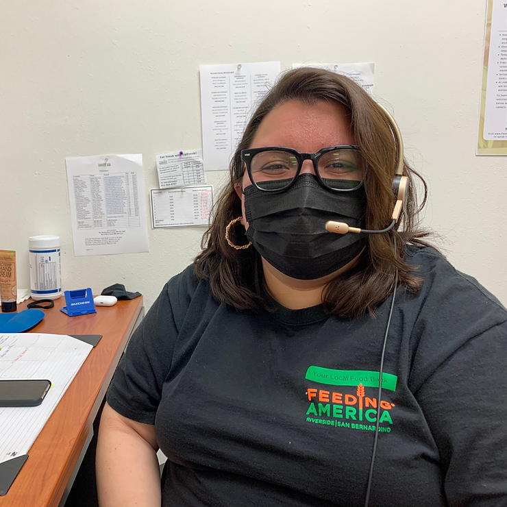 FARSB team member, Paulina Soria, Programs Director with headset on taking calls for SNAP application assistance.