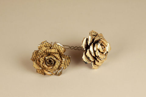 Product shot of earrings made of paper shot on beige background