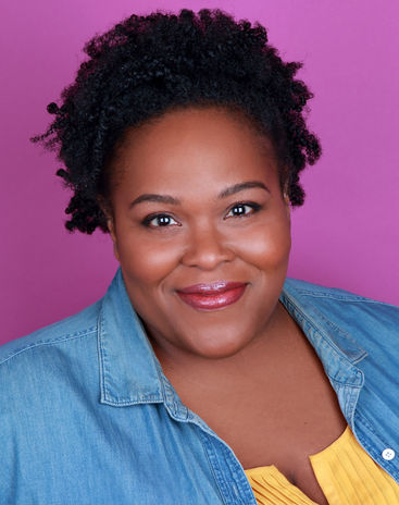 actor headshot of black woman in denim shirt, shot in studio with pink background