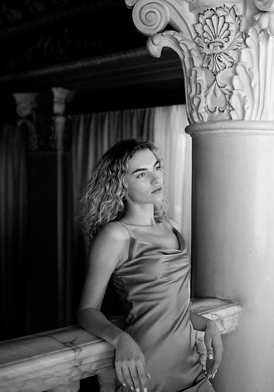 black-white-portrait-beautiful-woman-posing-indoors-dress.jpg