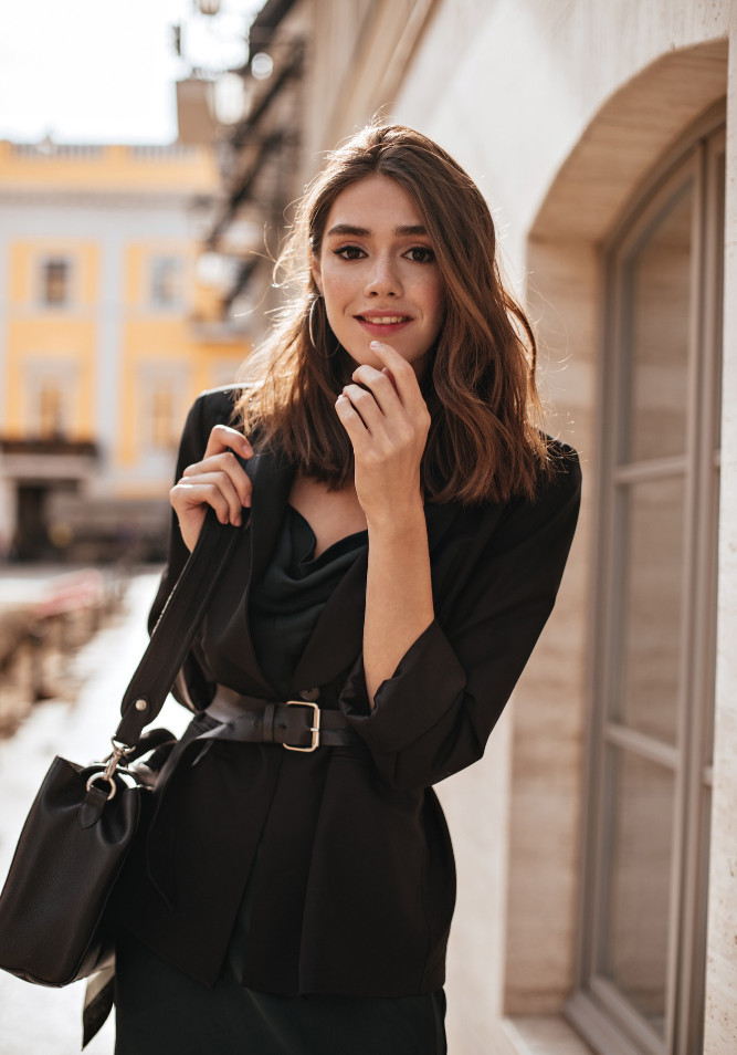 cute-young-girl-with-medium-wavy-hairstyle-modern-makeup-green-silk-dress-black-jacket-sty