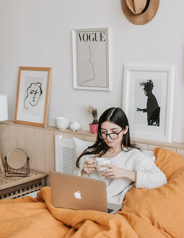 woman sitting next to laptop