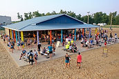 Sand volleyball courts with players during a league night at Sandlot Sports CR