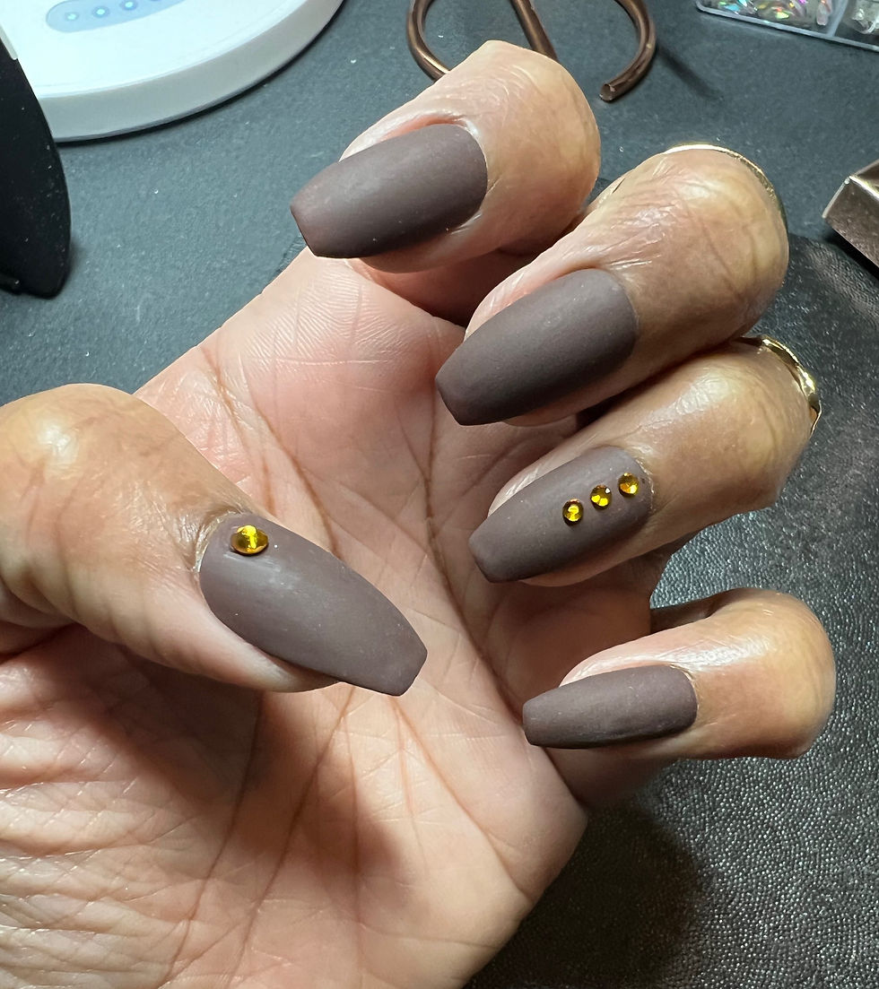 Short coffin, press-on nails in brown matte color with rhinestones on a hand