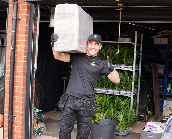 Buff Removals team member carrying a box during a garage removal in Bristol
