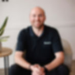 Dr. Austyn Wasko sitting on a chair smiling