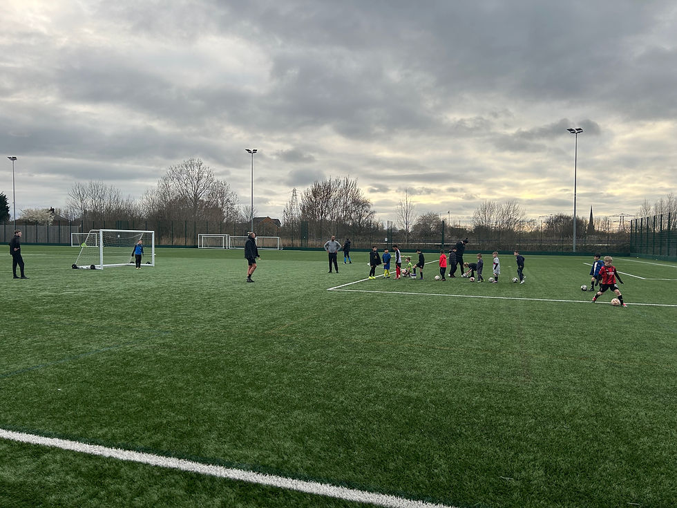 Eye-level view of a football training session with young athletes practicing drills