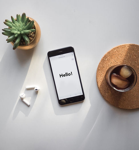 A smartphone displaying "Hello!" in a message.